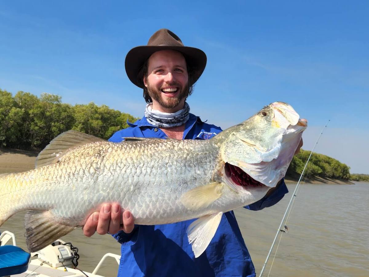 a person holding a fish in the water