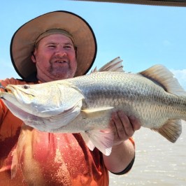 Jack Sheldon holding a fish in the water