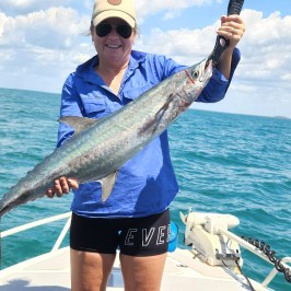 a person holding a fish in the water
