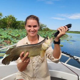 a person holding a fish in the water