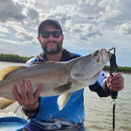 a man holding a fish swimming under water