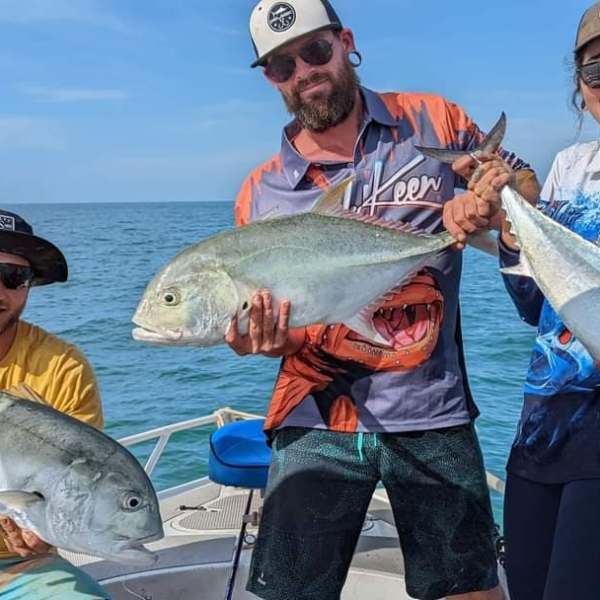 a person holding a fish in the water