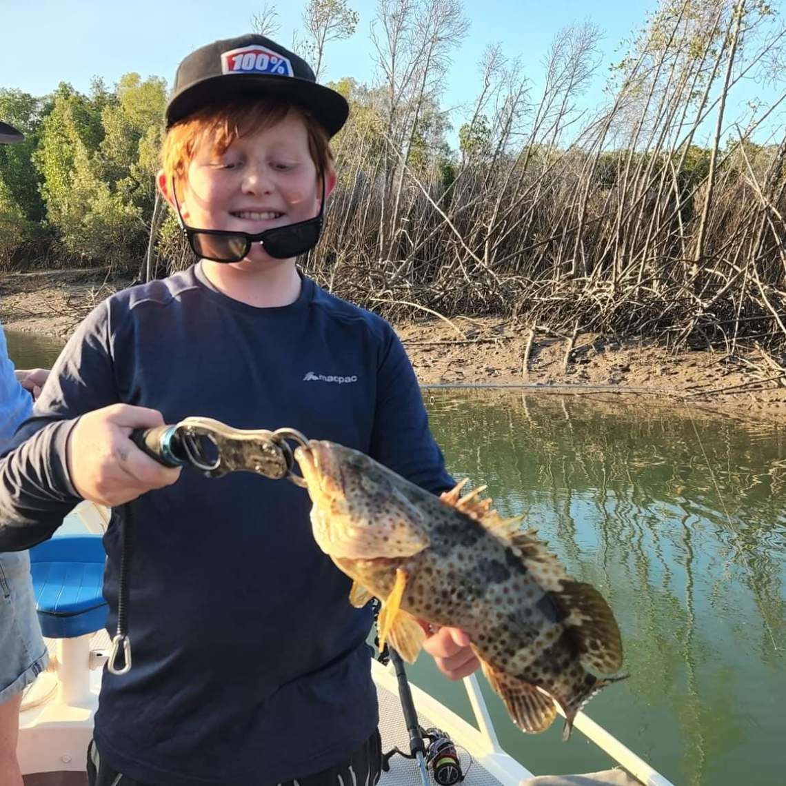 a man holding a fish in the water