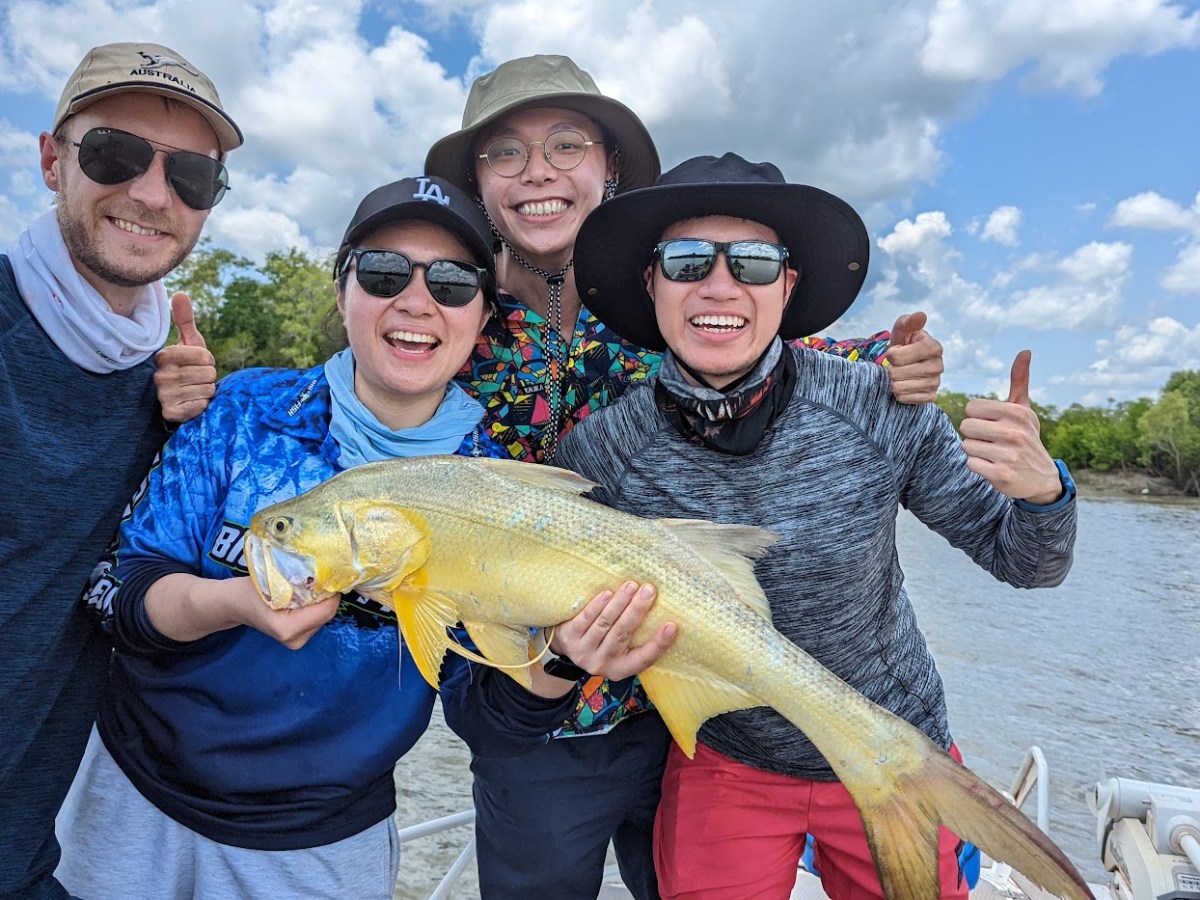 a man and a woman holding a fish