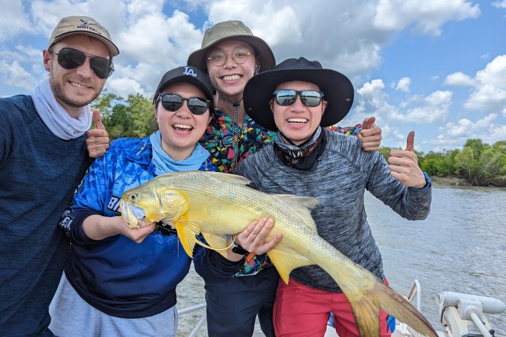 a man and a woman holding a fish