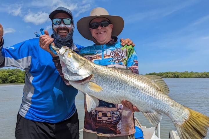 a person holding a fish in the water