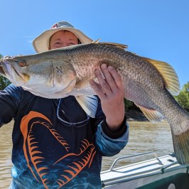 a person holding a fish in the water