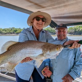 a person holding a fish in the water