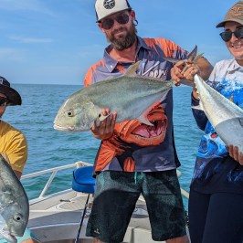 a person holding a fish in the water