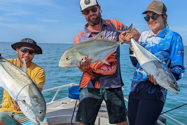 a person holding a fish in the water