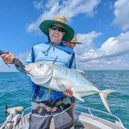 a man standing next to a body of water