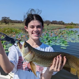 a person holding a fish in the water