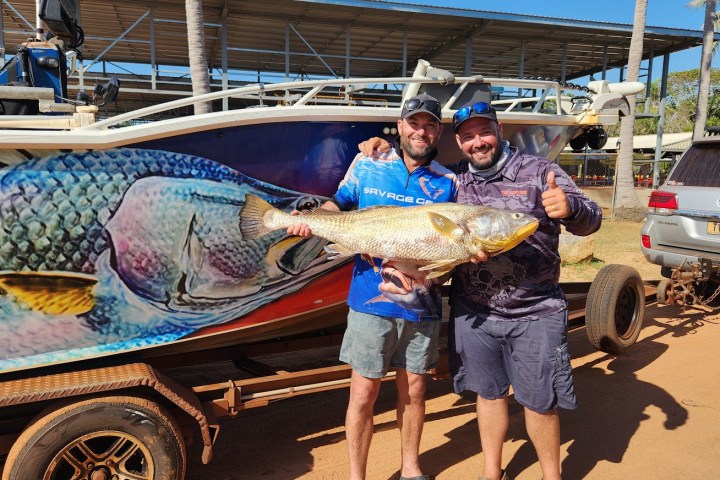 a man and a woman riding on the back of a truck