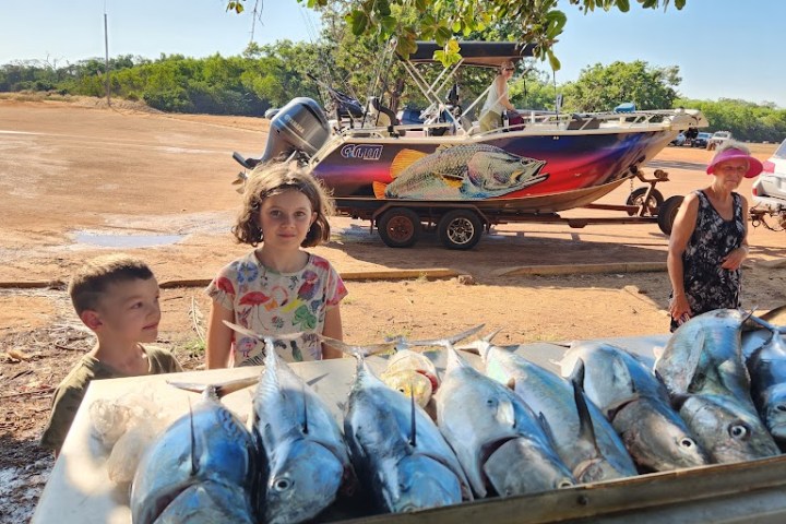 a group of people riding on the back of a truck