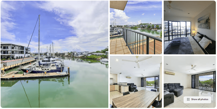 Marina view with boats, balcony, living room, and dining area.